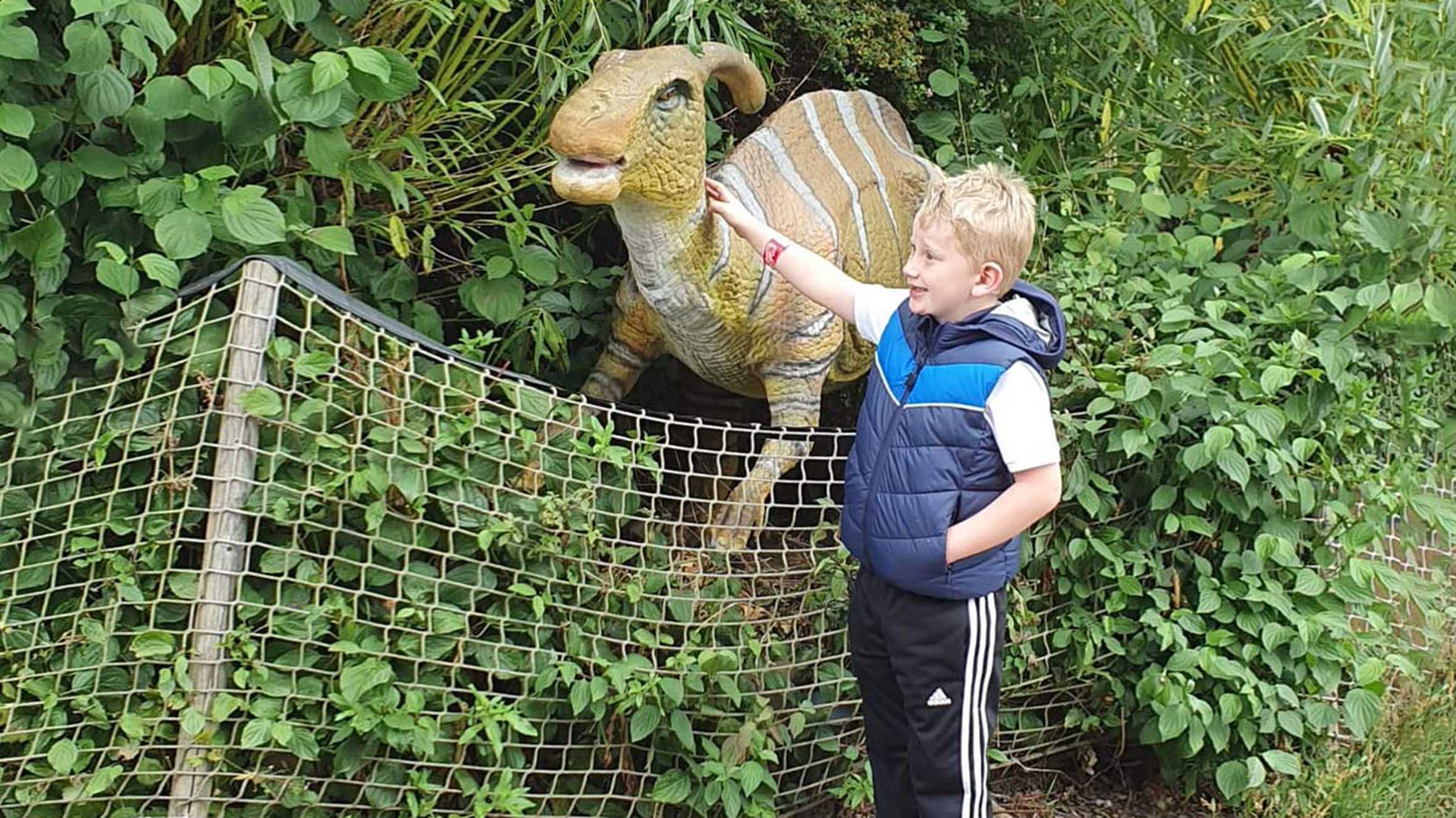 Lewis stroking a dinosaur