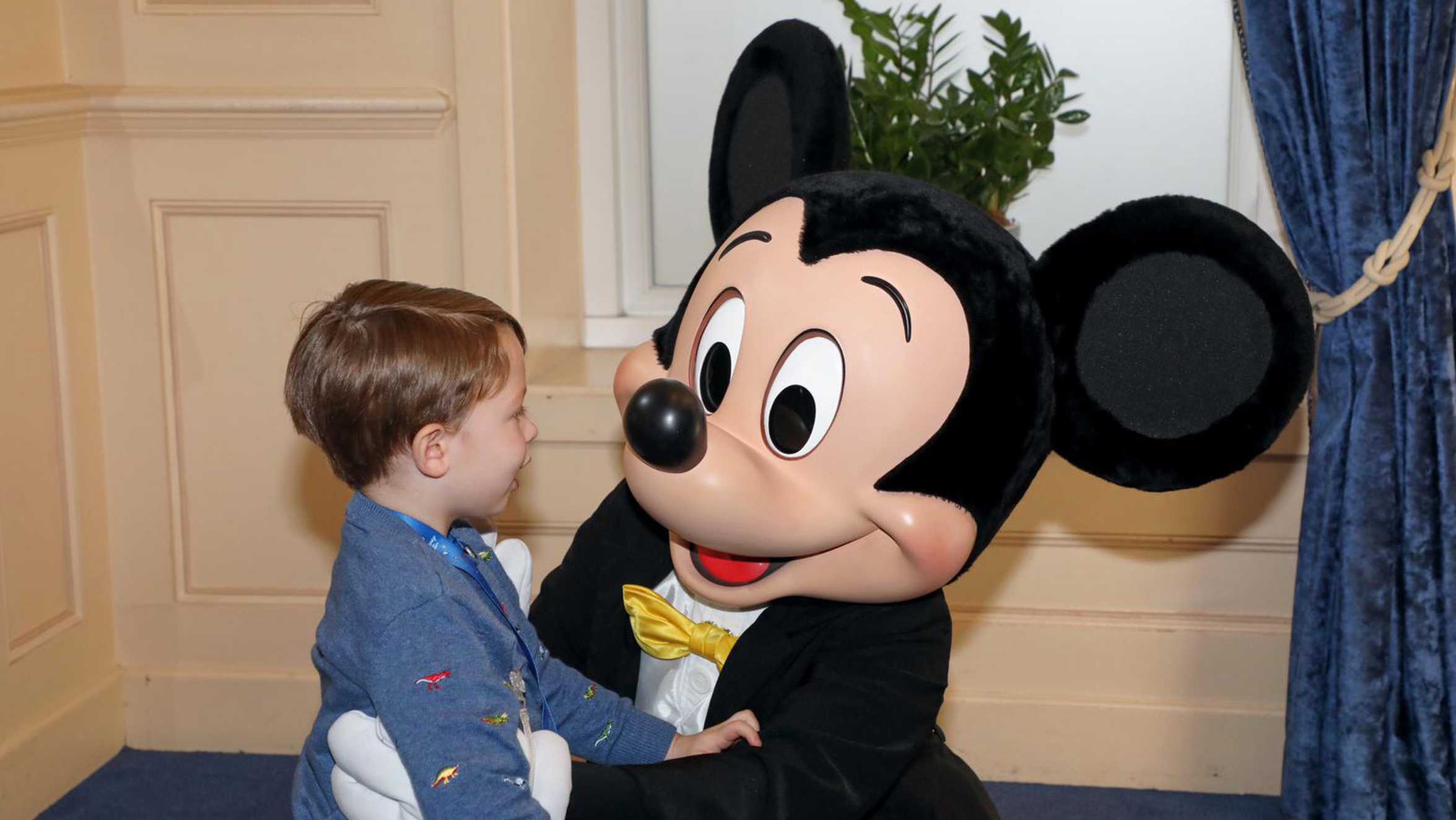 A smiling Archie meeting Mickey Mouse.