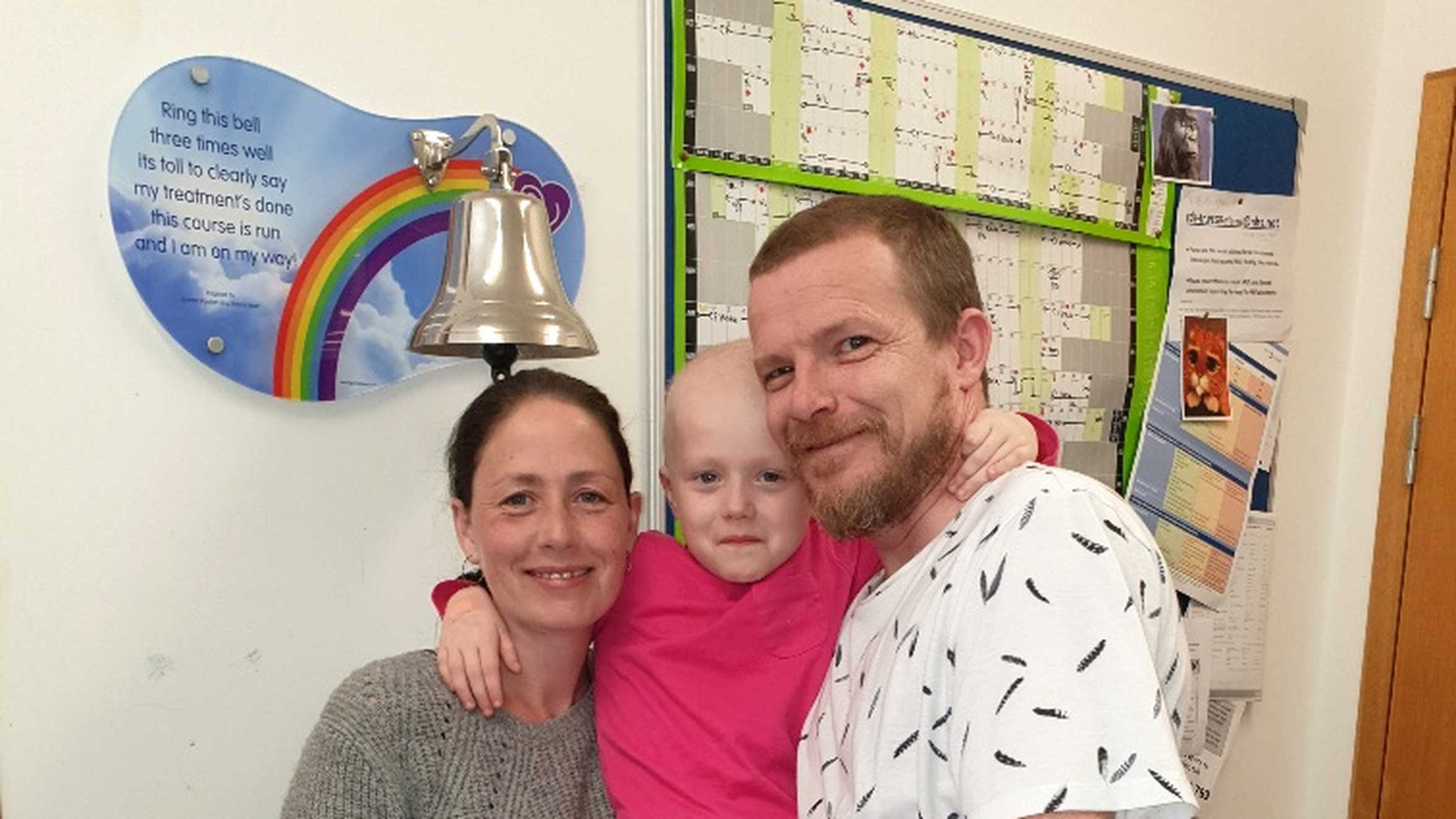 Wish child Lottie with her parents and the end of treatment bell